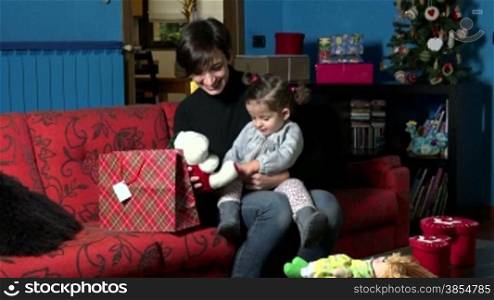 Happy mom and child, young woman with little girl, mother opening Christmas gift with baby. People, children, holidays at home, xmas, lifestyle, leisure, toys, doll. 3 of 5