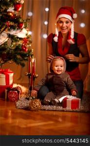 Happy mother and adorable baby in suit of Santa&rsquo;s little helper&#xA;