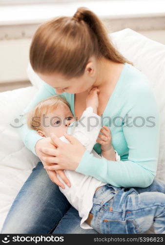 happy mother and adorable baby with feeding-bottle