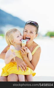 Happy mother and baby eating ice cream