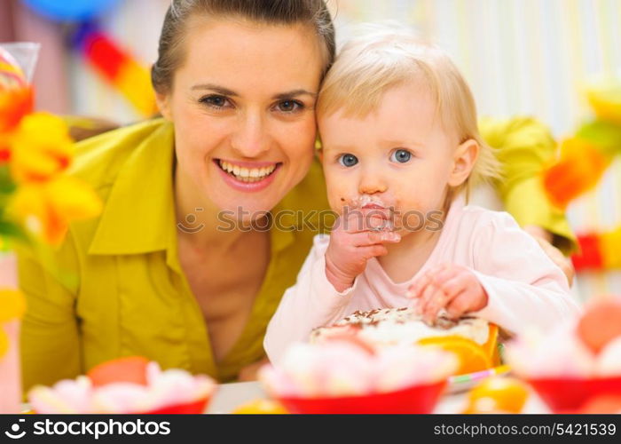 Happy mother and baby on first birthday celebration party