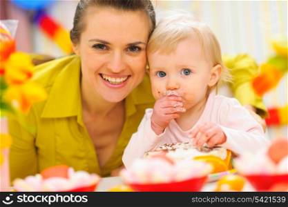 Happy mother and baby on first birthday celebration party