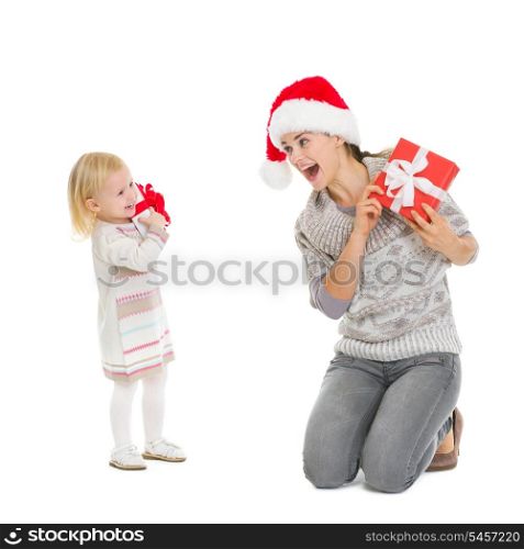 Happy mother and baby with Christmas present boxes