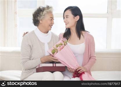 Happy mother and daughter and gifts