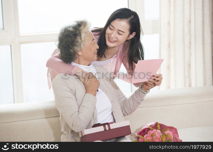 Happy mother and daughter and gifts