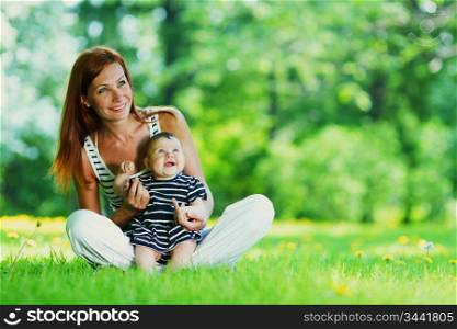 Happy mother and daughter on grass