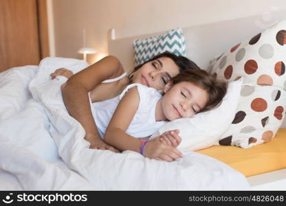 Happy mother and daughter together on bed