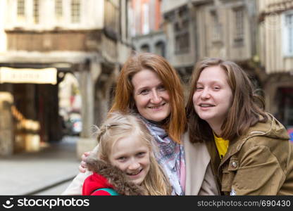 happy mother and daughters in the famous city of Dinan. Normandy, France