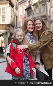 happy mother and daughters in the famous city of Dinan. Normandy, France