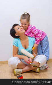 Happy mother and her daughter with repairing tools