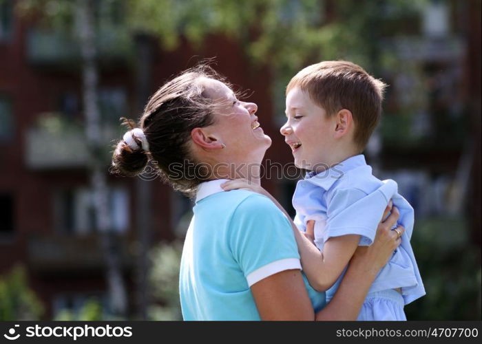 Happy mother and her little son outdoors session