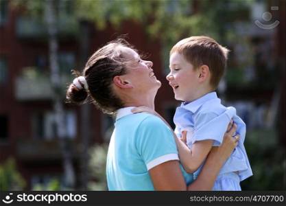 Happy mother and her little son outdoors session