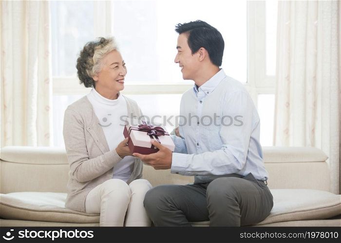 Happy mother and son and presents