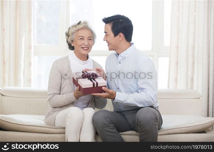 Happy mother and son and presents