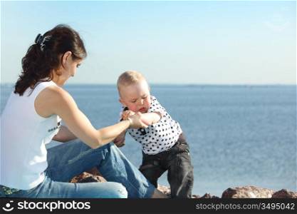 happy mother and son on picnic near sea