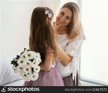 happy mother daughter with bouquet spring flowers