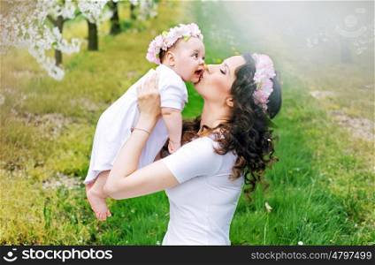 Happy mother kissing her cute little princess