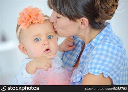 happy mother kissing with newborn baby