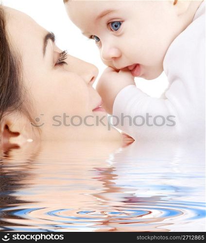 happy mother playing with baby boy in water #2