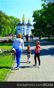 happy mother walks with her daughters. happy mother walks with her daughters in the spring park
