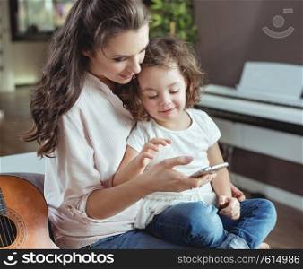 Happy mother with a little daughter at home