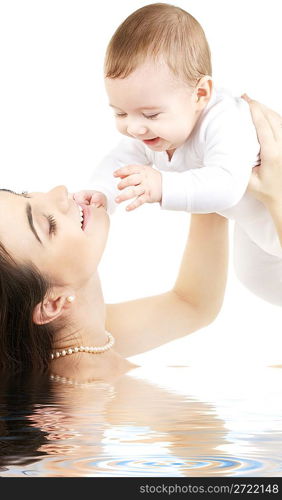 happy mother with baby boy in water