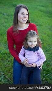 Happy mother with her little daughter in the garden