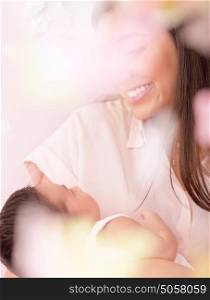 Happy mother with little newborn baby at home, embracing cute daughter, soft focus, enjoying parenthood, child care and healthy lifestyle concept