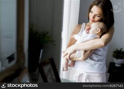 Happy mother with newborn baby girl