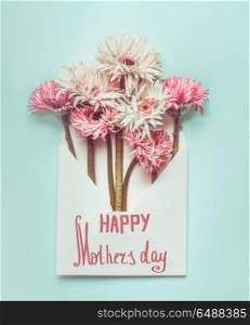 Happy Mothers day ! Greeting card with beautiful flowers bunch in envelope on pastel blue desktop background, Top view , copy space, flat lay