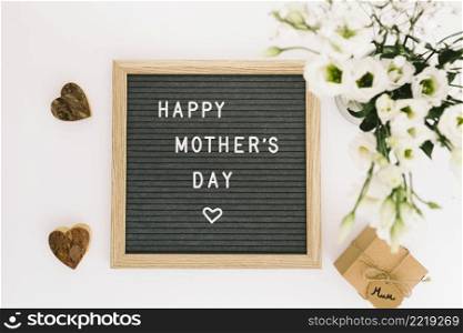 happy mothers day inscription board with flowers