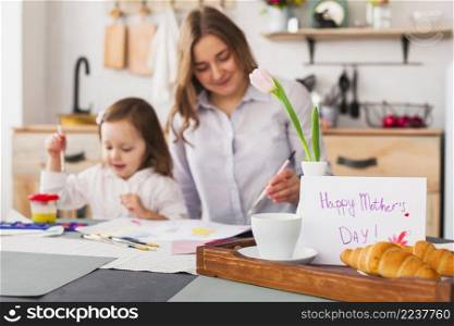 happy mothers day inscription table near painting daughter mother