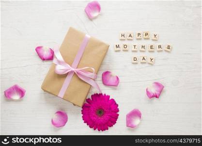 happy mothers day inscription with gift box gerbera