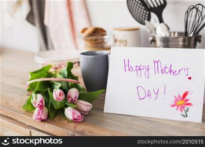 happy mothers day inscription with tulips table