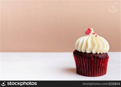Happy Mothers Day, sweet red heart on white cream cupcake