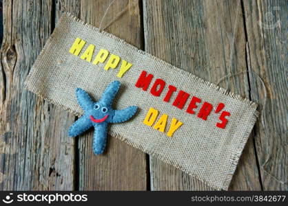 Happy mothers day with i love you mom message, idea from colorful fabric starfish on wooden background, beautiful flower, abstract wooden texture, mother&rsquo;s day is day for mom, love of family