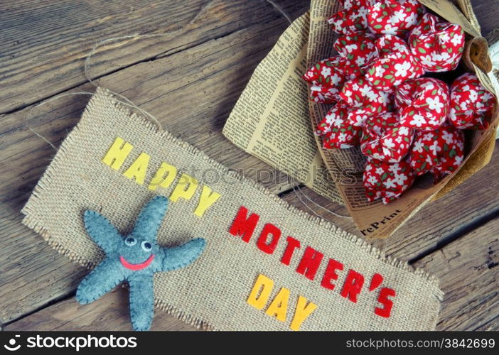 Happy mothers day with i love you mom message, idea from colorful fabric starfish on wooden background, beautiful flower, abstract wooden texture, mother&rsquo;s day is day for mom, love of family