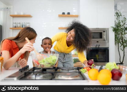 Happy multiethnic family cooking together in the kitchen at home.