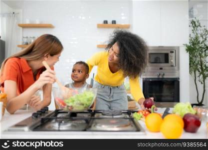 Happy multiethnic family cooking together in the kitchen at home.