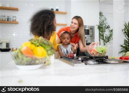 Happy multiethnic family cooking together in the kitchen at home.