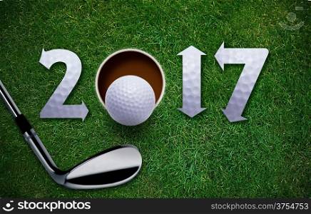 Happy New Golf year 2017, Golf ball and putter on green grass.