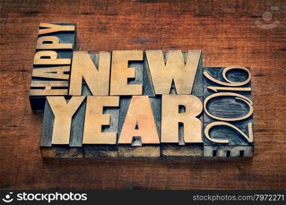 Happy New Year 2016 greetings - text in grunge letterpress wood type blocks on a rustic wooden background
