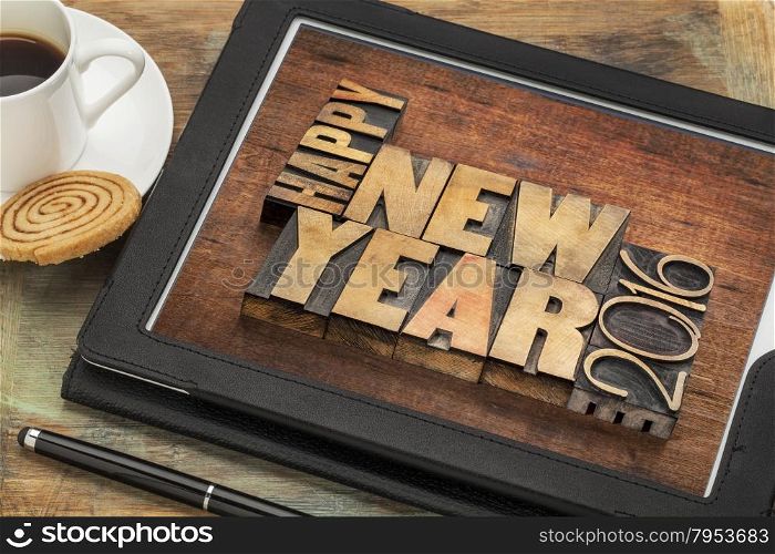 Happy New Year 2016 greetings - text in vintage letterpress wood type blocks on a digital tablet with a cup of coffee