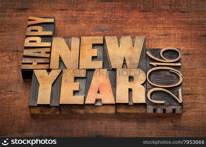 Happy New Year 2016 greetings - word abstract in vintage letterpress wood type blocks on a grunge wooden background