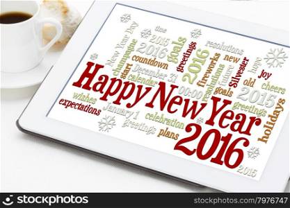 Happy New Year 2016 greetings - word cloud on a digital tablet with a cup of coffee