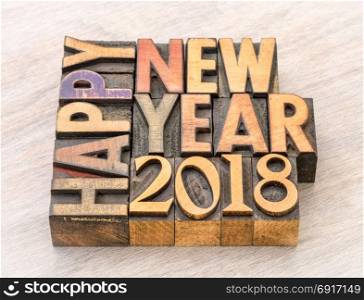 Happy New Year 2018 greeting card - text in vintage letterpress wood type blocks on a grained wooden background