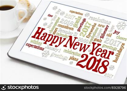 Happy New Year 2018 greetings card - word cloud on a digital tablet with a cup of coffee