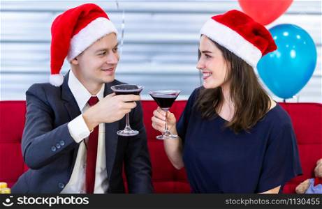 Happy new year 2020 concept,Happy couple holding glasses of Clinking Champagne in Christmas and New Year&rsquo;s Eve party After finishing business work