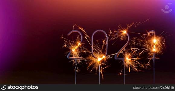 Happy New Year 2021 banner template. Digits of year 2021 made by burning sparklers isolated on black background.