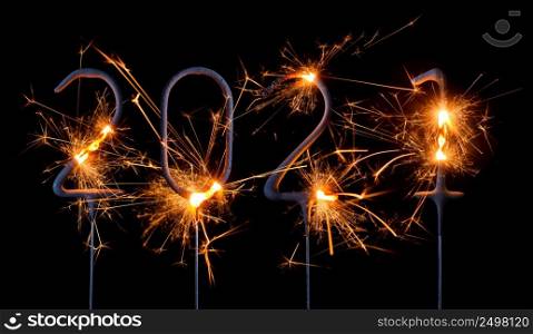Happy New Year 2021. Digits of year 2021 made by burning sparklers isolated on black background.